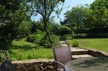 French windows from the living-area open onto your sheltered patio, with the lovely garden beyond it.