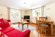 The open plan living-room has French doors out to the patio and walled garden.