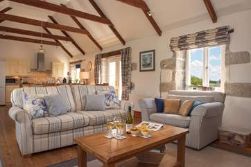 The lovely open plan living-space where you can snuggle up on the sofas.