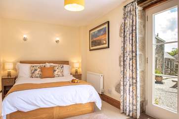 This bedroom has a door that opens to the courtyard (Bedroom 4).
