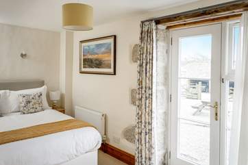 The French doors lead outside to the courtyard from bedroom 4.