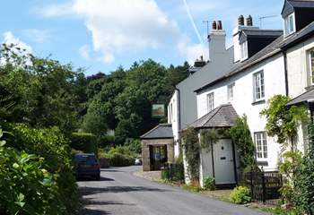 The village street with the pub down the road on the right.