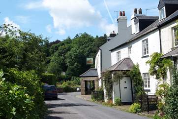 The village street with the pub down the road on the right.