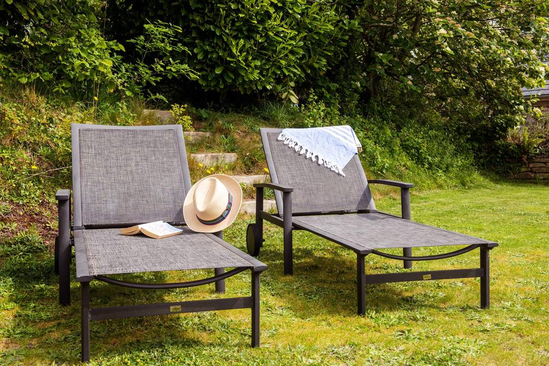 The upper terrace has a lawned-area, perfect for relaxing on the loungers.