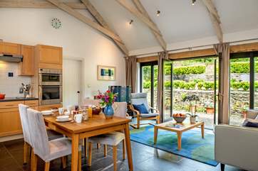 The high vaulted ceiling and large windows make the living-area wonderfully light and airy.