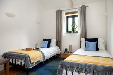 Twin beds await in the second bedroom