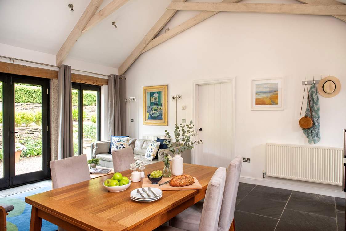 The high vaulted ceiling and large windows make the living-area wonderfully light and airy.