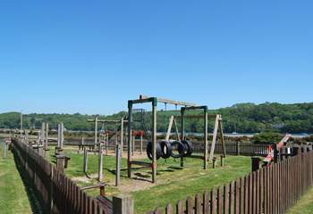 The children's play-park in Golant, safely fenced by the inner harbour.