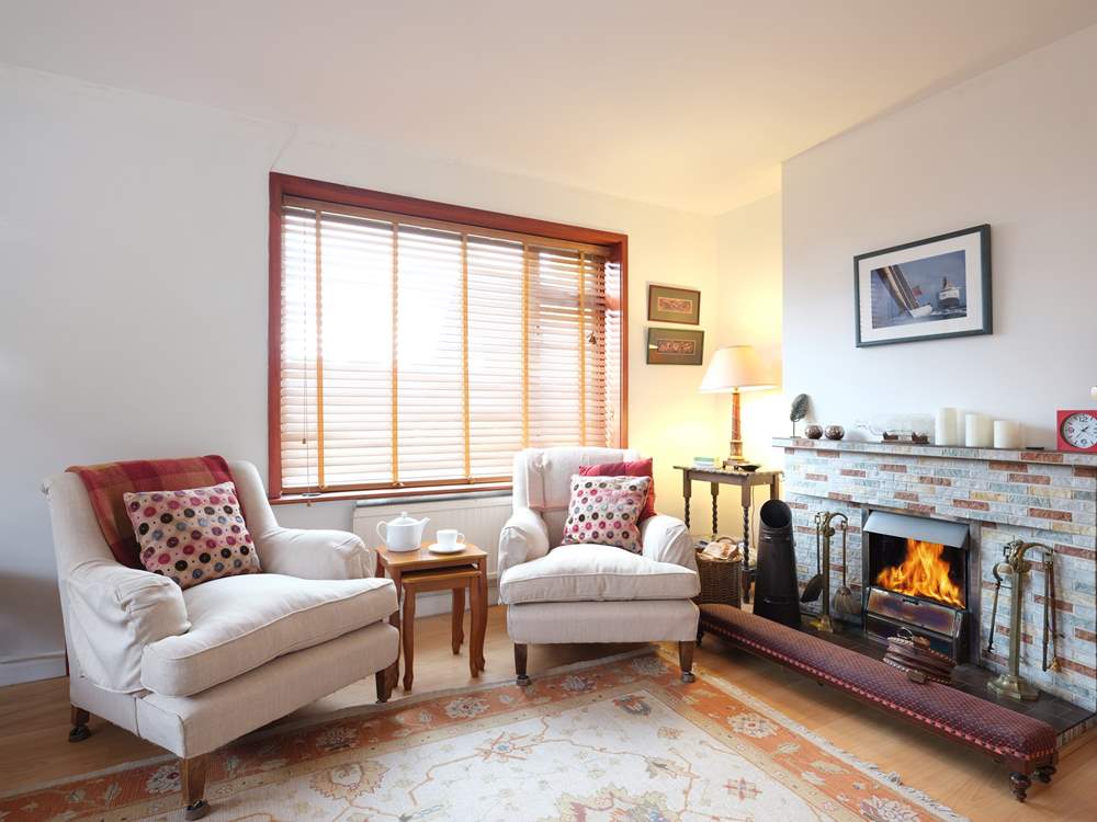 The sitting-room has a cosy fire.