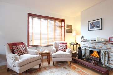 The sitting-room has a cosy fire.