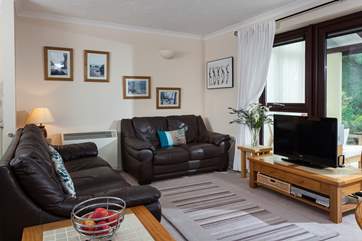 The open plan living space opens into the conservatory which leads to the patio.