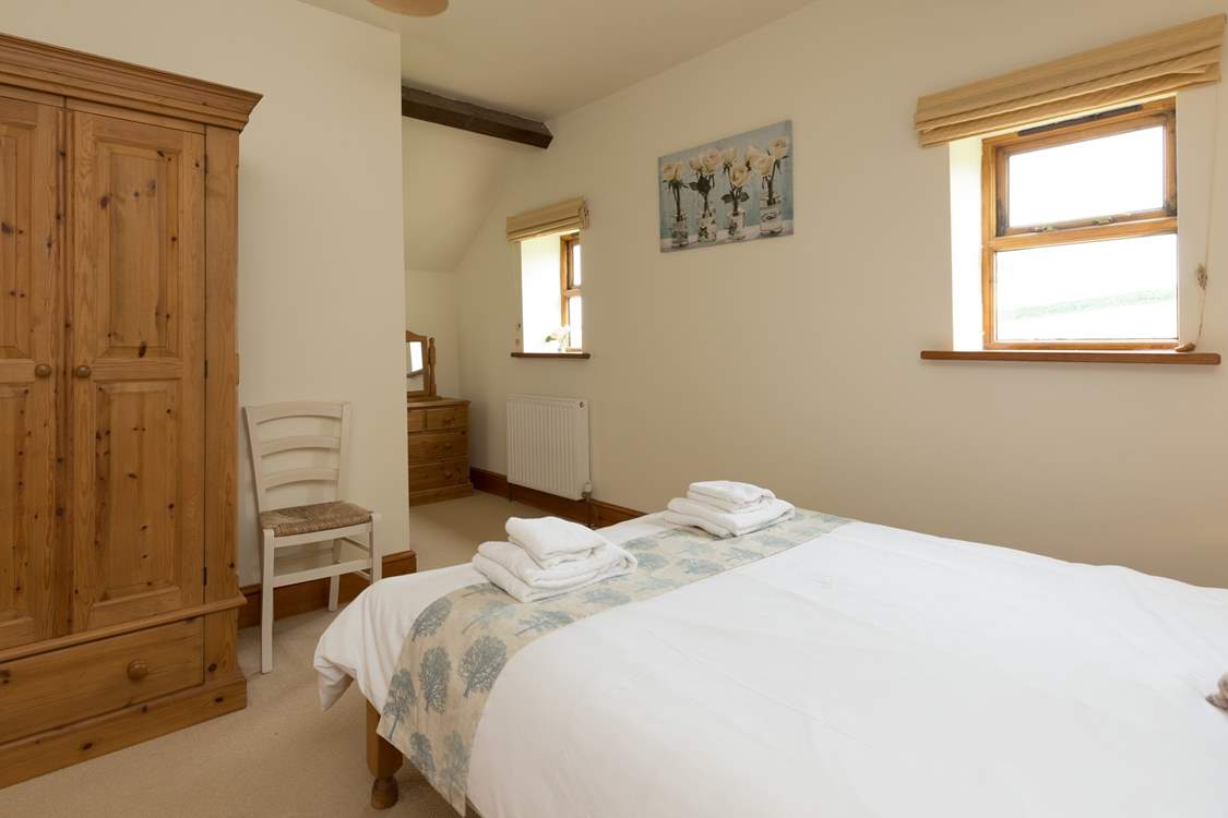 The en suite is at the far end of the room.