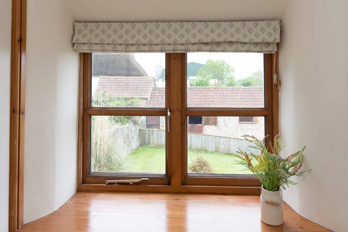 The single bedroom overlooks the hot tub and the garden beyond.