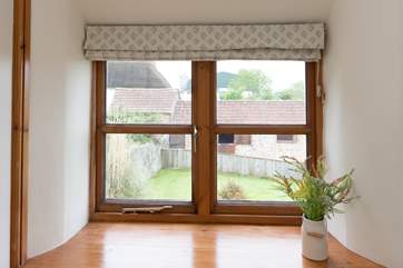 The single bedroom overlooks the hot tub and the garden beyond.