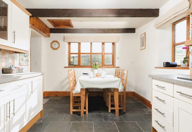 The farmhouse-style kitchen has flagstone floors and is equipped as a home-from-home.