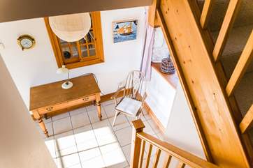 Looking down the stairway to the hall, a great place to sit and read or plan your next adventure.