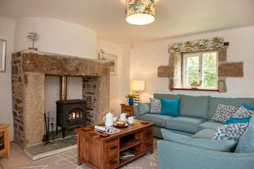 The lovely open plan living-room with comfy sofas around the wood-burner.