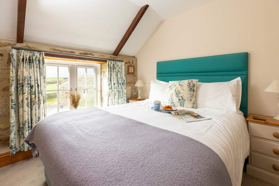 Bedroom 1 has views across the courtyard.