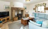 The lovely open plan living-room with comfy sofas around the wood-burner. - Thumbnail Image