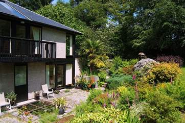 The dining-area looks out over the lower patio, which includes a small covered pond.