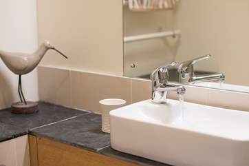 Slate-topped surfaces in the en suite shower-room.
