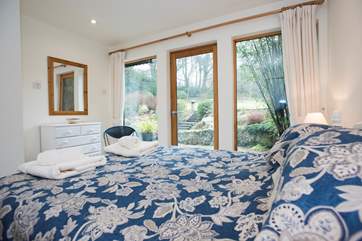 Bedroom 2 has garden views and a door out to the garden.