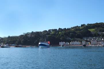 Fishing boats coming in through the estuary mouth to moor in Teignmouth.