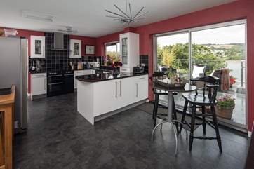 The open plan feel of the kitchen/diner is complimented by the patio doors, which lead straight onto the decking and hot tub area.