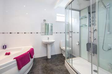 The family bathroom on the lower level has this superb corner bath and power shower.