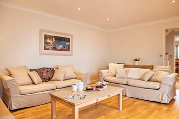 The sitting-room on the first floor has comfy sofas to relax on.