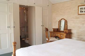 The beautifully crafted wardrobe hides the gorgeous bathroom.