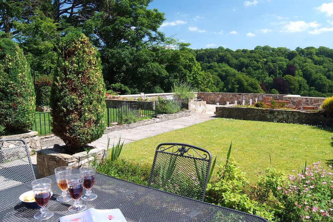 Looking down the pretty garden, separated from next door by a low wall and a low fence.