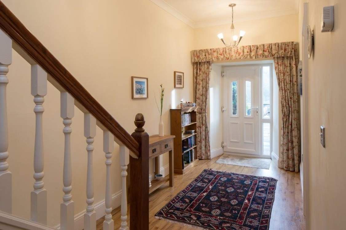 The back door at the end of the hall leads out to the patio and garden.
