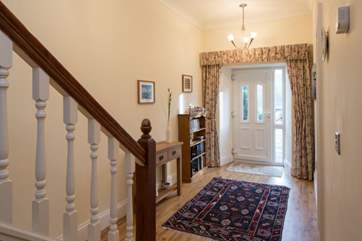 The back door at the end of the hall leads out to the patio and garden.