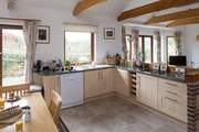 The kitchen is fully equipped and creates a very sociable open space.