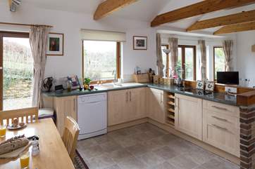 The kitchen is fully equipped and creates a very sociable open space.