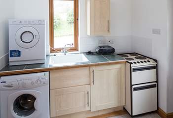 The spacious utility-room has all the appliances that you will need.