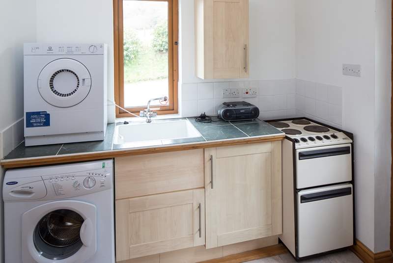 The spacious utility-room has all the appliances that you will need.