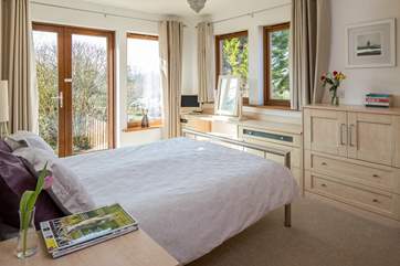 The master en-suite bedroom has French doors leading out onto the rear terrrace.