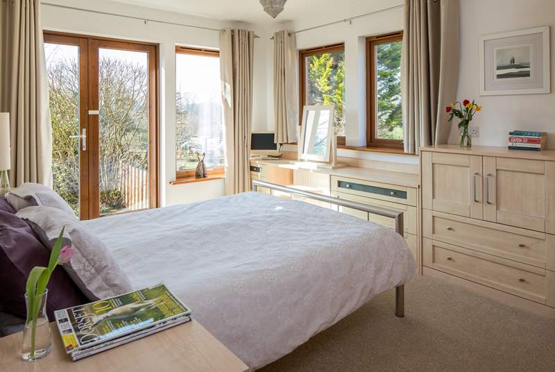 The master en-suite bedroom has French doors leading out onto the rear terrrace.