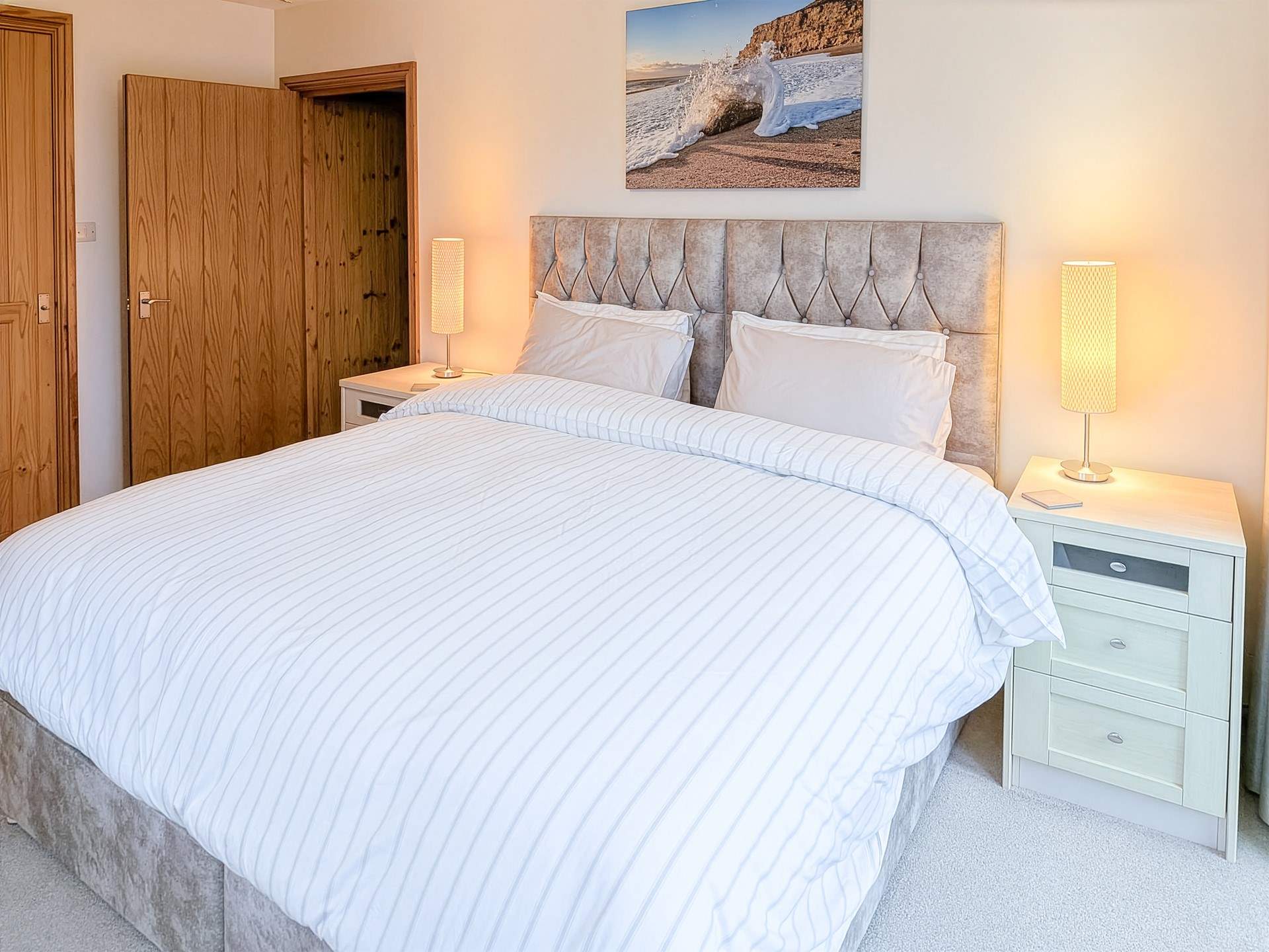 The  lovely master en-suite bedroom has French doors leading out onto the rear terrace and a very tempting super-king (zip and link) bed.