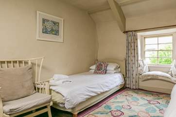 The larger bedroom has an extra single bed for flexibility.