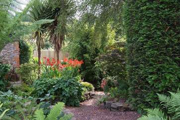 The fully enclosed garden is magical, with a hidden seat around a corner by the brook, as well as the patio outside the cottage.