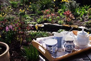Sit on the terrace outside the cottage and take in all the wonderful detail in this special garden.