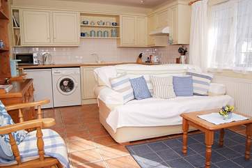 The living-room has a really well-equipped kitchen at the far end.