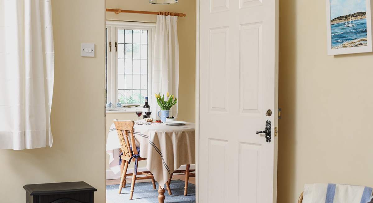 Looking across the living-area towards the dining-room/garden-room in this bright and cheerful cottage.