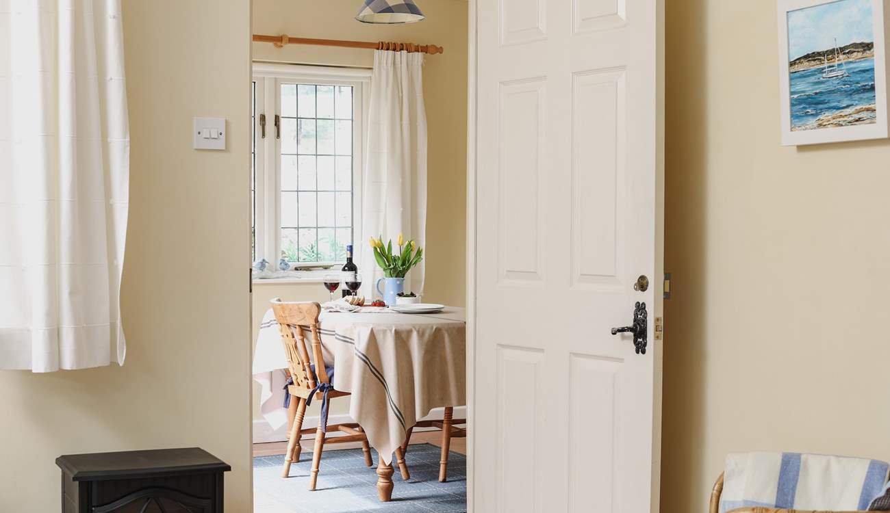 Looking across the living-area towards the dining-room/garden-room in this bright and cheerful cottage.