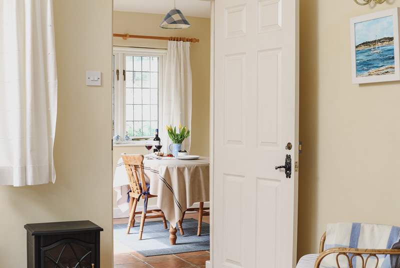 Looking across the living-area towards the dining-room/garden-room in this bright and cheerful cottage.