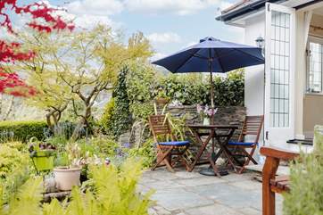 Sit on the terrace outside the cottage and take in all the wonderful detail in this special garden.