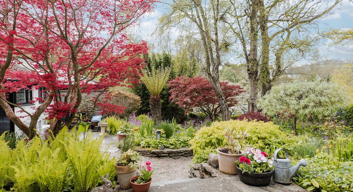 The fully enclosed garden is magical, with a hidden seat around a corner by the brook, as well as the patio outside the cottage.